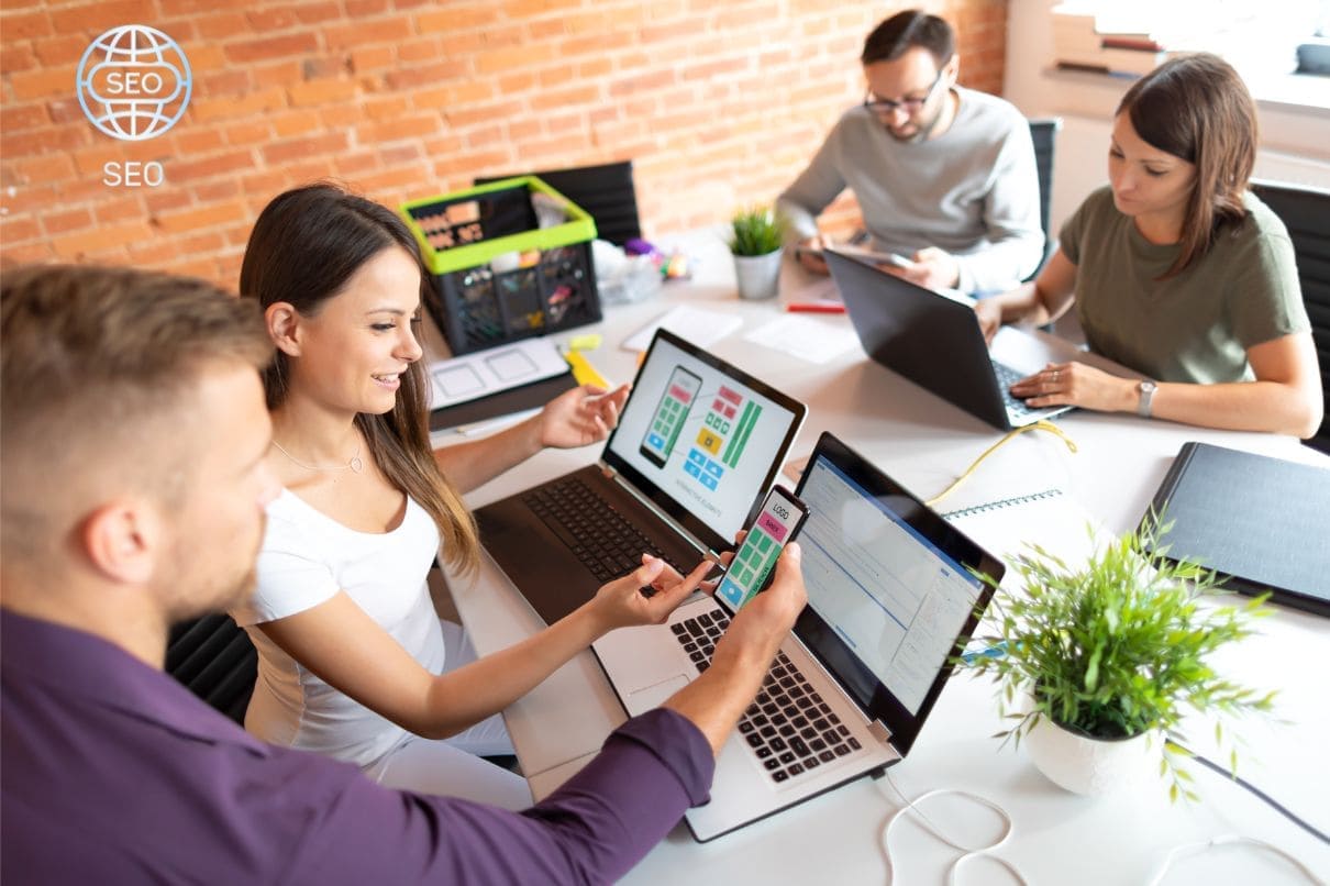 A diverse team of professionals diligently working on their laptops in a modern office setting.